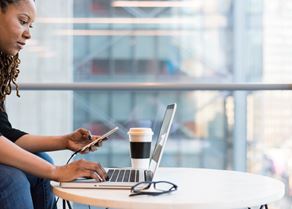 Woman on laptop and phone stock image.jpg